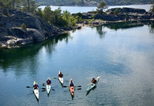 five paddlers on the water